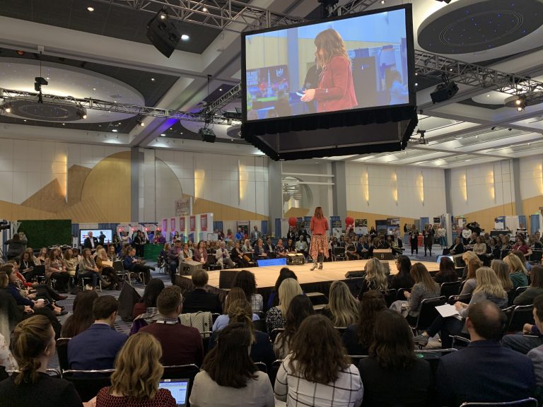 Guests watching a presentation by MIC of Colorado