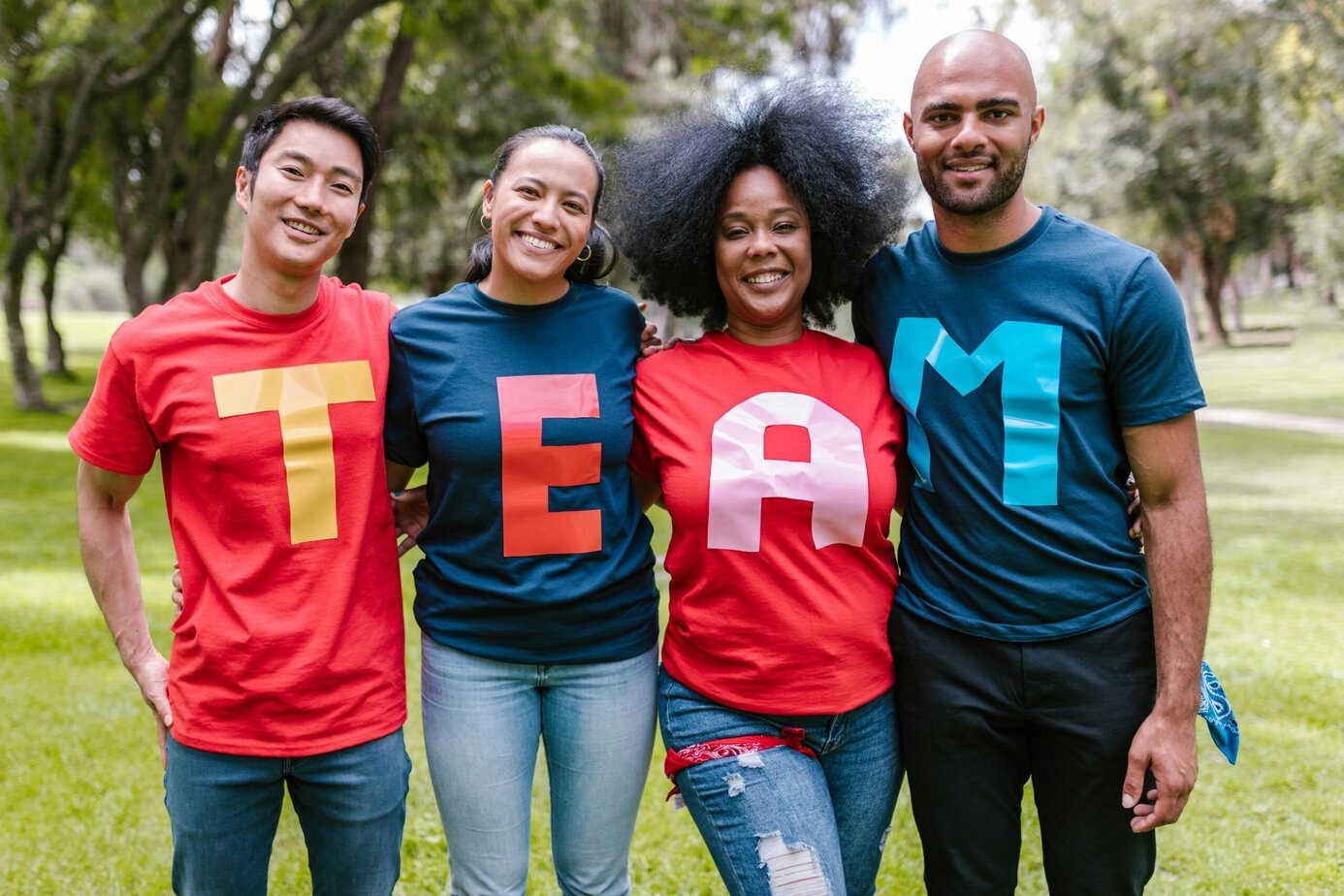 group of people at a team building event wearing t-shirts that spell out Team